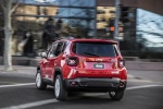 Picture of a driving 2016 Jeep Renegade Latitude 4WD in Colorado Red from a rear left perspective