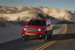 Picture of a driving 2017 Jeep Renegade Latitude 4WD in Colorado Red from a front left perspective