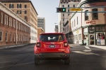Picture of a driving 2017 Jeep Renegade Latitude 4WD in Colorado Red from a rear perspective
