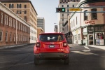 Picture of a driving 2018 Jeep Renegade Latitude 4WD in Colorado Red from a rear perspective