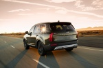 Picture of a driving 2020 Kia Telluride AWD in Dark Moss from a rear left perspective