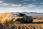 Picture of a driving 2020 Kia Telluride AWD in Dark Moss from a front right three-quarter perspective