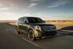 Picture of a driving 2020 Kia Telluride AWD in Dark Moss from a front right perspective