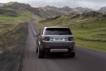 Picture of a driving 2015 Land Rover Discovery Sport HSE Luxury in Scotia Gray Metallic from a rear perspective