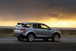 Picture of a driving 2015 Land Rover Discovery Sport HSE Luxury in Indus Silver Metallic from a rear right three-quarter perspective