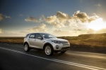 Picture of a driving 2015 Land Rover Discovery Sport HSE Luxury in Indus Silver Metallic from a front right three-quarter perspective