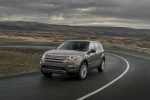 Picture of a driving 2015 Land Rover Discovery Sport HSE Luxury in Kaikoura Stone Metallic from a front left perspective