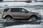 Picture of a driving 2015 Land Rover Discovery Sport HSE Luxury in Kaikoura Stone Metallic from a right side perspective