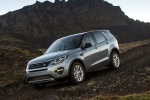 Picture of a driving 2015 Land Rover Discovery Sport HSE Luxury in Scotia Gray Metallic from a front left three-quarter perspective