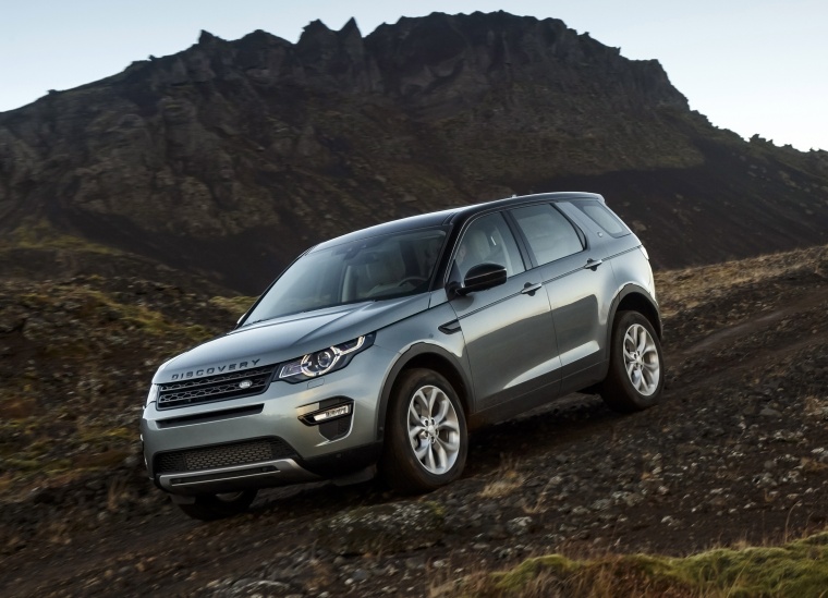 Picture of a driving 2018 Land Rover Discovery Sport HSE Luxury in Scotia Gray Metallic from a front left three-quarter perspective