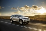 Picture of a driving 2018 Land Rover Discovery Sport HSE Luxury in Indus Silver Metallic from a front right three-quarter perspective