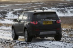 Picture of a driving 2019 Land Rover Discovery Sport HSE Luxury from a rear left perspective
