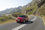 Picture of a driving 2020 Land Rover Discovery Sport P290 HSE R-Dynamic in Firenze Red Metallic from a front left perspective