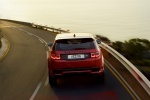 Picture of a driving 2020 Land Rover Discovery Sport P290 HSE R-Dynamic in Firenze Red Metallic from a rear perspective