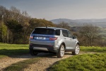 Picture of a driving 2020 Land Rover Discovery Sport P250 S in Byron Blue Metallic from a rear right three-quarter perspective