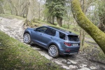 Picture of a driving 2020 Land Rover Discovery Sport P250 S in Byron Blue Metallic from a rear left three-quarter top perspective