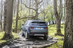 Picture of a driving 2020 Land Rover Discovery Sport P250 S in Byron Blue Metallic from a rear left perspective