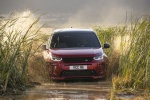 Picture of a driving 2020 Land Rover Discovery Sport P290 HSE R-Dynamic in Firenze Red Metallic from a frontal perspective