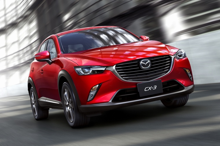 Picture of a driving 2016 Mazda CX-3 in Soul Red Metallic from a front right perspective