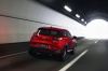 Picture of a driving 2016 Mazda CX-3 in Soul Red Metallic from a rear right perspective