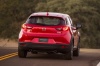Picture of a driving 2016 Mazda CX-3 in Soul Red Metallic from a rear perspective