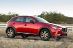 Picture of a driving 2016 Mazda CX-3 in Soul Red Metallic from a front right three-quarter perspective