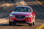 Picture of a driving 2016 Mazda CX-3 in Soul Red Metallic from a front left perspective