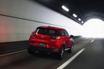 Picture of a driving 2017 Mazda CX-3 in Soul Red Metallic from a rear right perspective