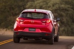 Picture of a driving 2017 Mazda CX-3 in Soul Red Metallic from a rear perspective