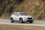 Picture of a driving 2017 Mazda CX-3 AWD in Crystal White Pearl Mica from a front right three-quarter perspective