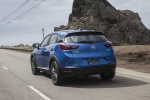 Picture of a driving 2017 Mazda CX-3 in Dynamic Blue Mica from a rear left perspective
