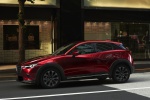 Picture of a driving 2019 Mazda CX-3 in Soul Red Crystal Metallic from a front left three-quarter perspective