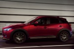 Picture of a driving 2019 Mazda CX-3 in Soul Red Crystal Metallic from a side perspective
