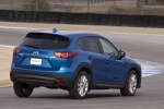 Picture of a driving 2014 Mazda CX-5 in Sky Blue Mica from a rear right three-quarter perspective