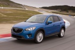 Picture of a driving 2014 Mazda CX-5 in Sky Blue Mica from a front left three-quarter perspective