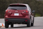 Picture of a driving 2014 Mazda CX-5 from a rear perspective