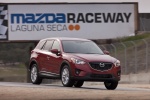 Picture of a driving 2014 Mazda CX-5 from a front right three-quarter perspective
