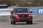 Picture of a driving 2014 Mazda CX-5 from a frontal perspective