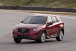 Picture of a driving 2014 Mazda CX-5 from a front left perspective
