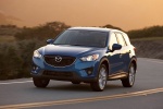 Picture of a driving 2014 Mazda CX-5 in Sky Blue Mica from a front left perspective