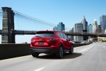 Picture of a driving 2016 Mazda CX-5 AWD in Soul Red Metallic from a rear right perspective