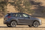 Picture of a driving 2016 Mazda CX-5 in Meteor Gray Mica from a rear right three-quarter perspective