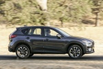 Picture of a driving 2016 Mazda CX-5 in Meteor Gray Mica from a side perspective
