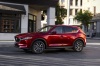 Picture of a driving 2017 Mazda CX-5 Grand Touring AWD in Soul Red Crystal Metallic from a front left three-quarter perspective