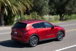 Picture of a driving 2017 Mazda CX-5 Grand Touring AWD in Soul Red Crystal Metallic from a rear right three-quarter perspective