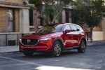 Picture of a driving 2017 Mazda CX-5 Grand Touring AWD in Soul Red Crystal Metallic from a front left perspective