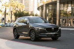 Picture of a driving 2017 Mazda CX-5 in Machine Gray Metallic from a front right three-quarter perspective