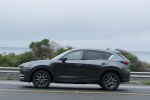 Picture of a driving 2017 Mazda CX-5 in Machine Gray Metallic from a side perspective