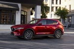 Picture of a driving 2018 Mazda CX-5 Grand Touring AWD in Soul Red Crystal Metallic from a front left three-quarter perspective
