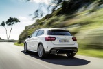 Picture of a driving 2019 Mercedes-AMG GLA 45 4MATIC in Polar White from a rear left perspective